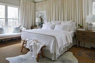 A bright and airy bedroom with Red Land Cotton bedding, styled with fresh, floral accents and light pastel colors for a springtime vibe.