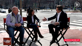 Eric Bolling seated for an interview, with a backdrop of Red Land Cotton products, discussing the importance of quality and craftsmanship.